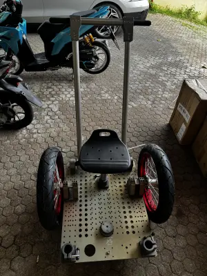 Camera RICKSHAW - one main and one auxiliary pull handle, two wheels, one adjustable seat post, two detachable axles, three main support rods, four stabilizing rods (two extended to rear), and four cross connectors