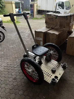 Camera RICKSHAW - one main and one auxiliary pull handle, two wheels, one adjustable seat post, two detachable axles, three main support rods, four stabilizing rods (two extended to rear), and four cross connectors
